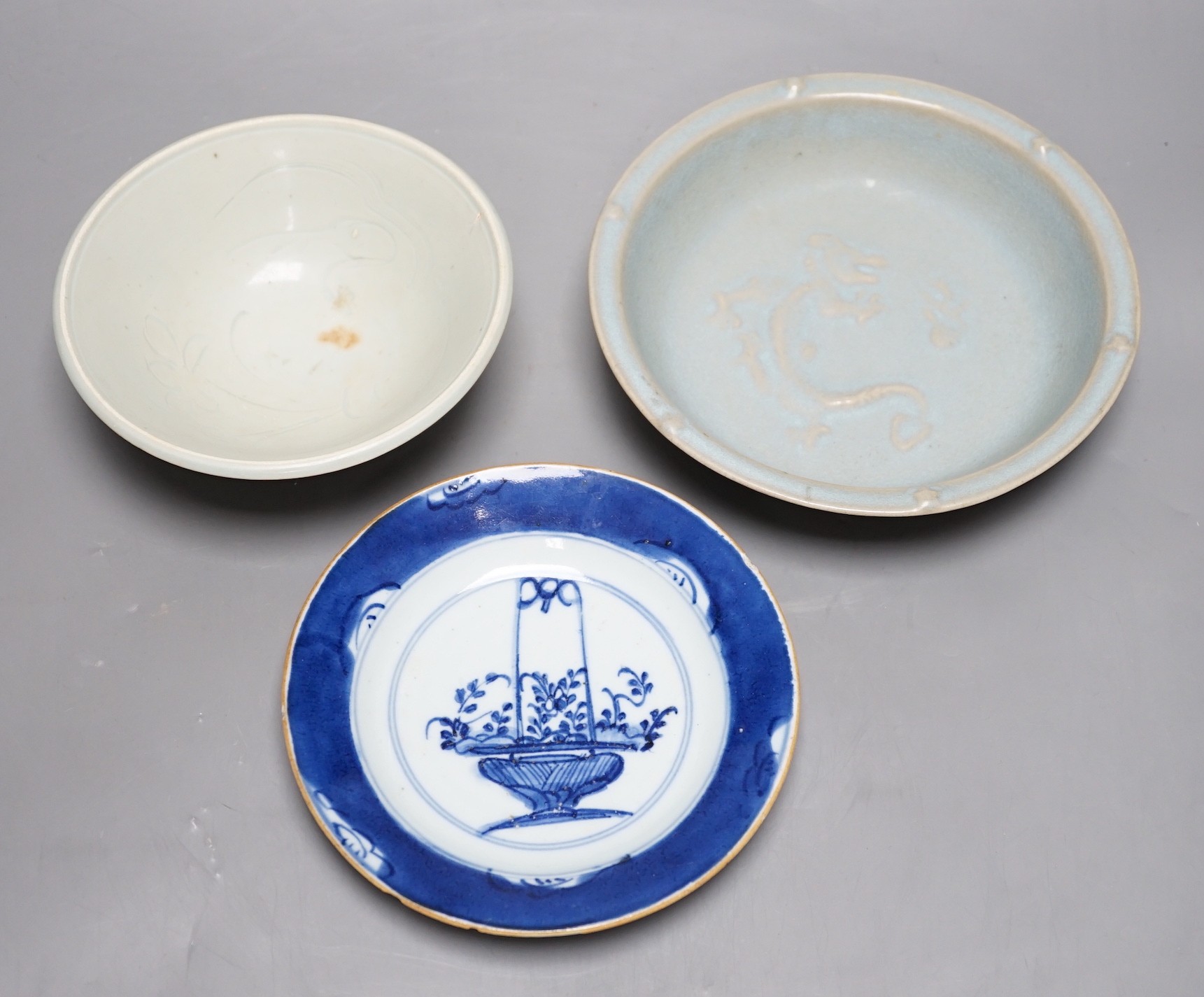 A group of three Chinese ceramics; a Qing Bai style bowl, a Jun style bowl with dragon relief decor and inscription to base, and a blue and white dish, tallest 6cm